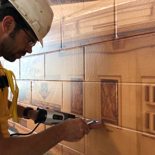 Man working on the wall graphic