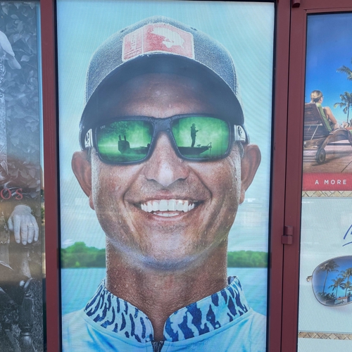 Smiling man in cap and shades