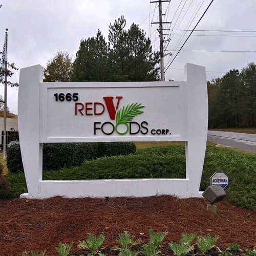 The Red V food corp signage on the grass