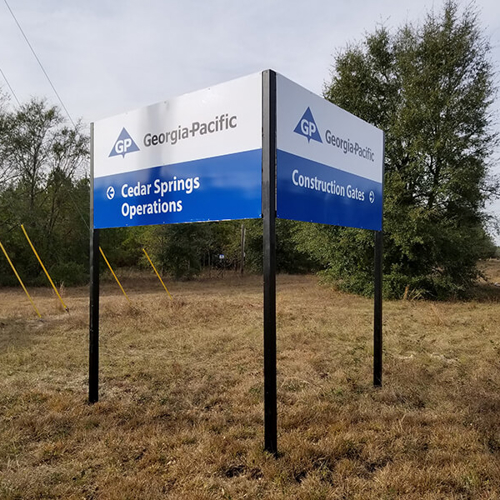 Georgia Pacific Signage with directions in a empty lot with tress and plants
