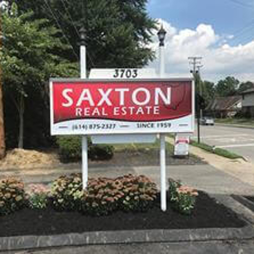 Saxton real estate signage on the side of the road