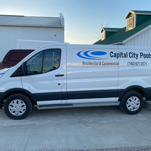 White truck with lettering of capitol city pools