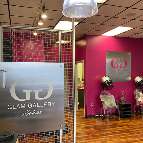 Glam gallery interior decor with salon equipment and custom decal