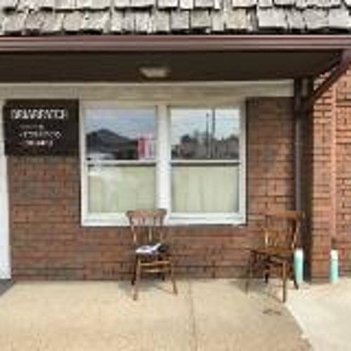Briarpatch Signage with chair outside the store