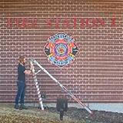 Installation building sign with man holding a ladder