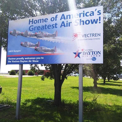Vectren Dayton Air show banner on a lot with trees and grass