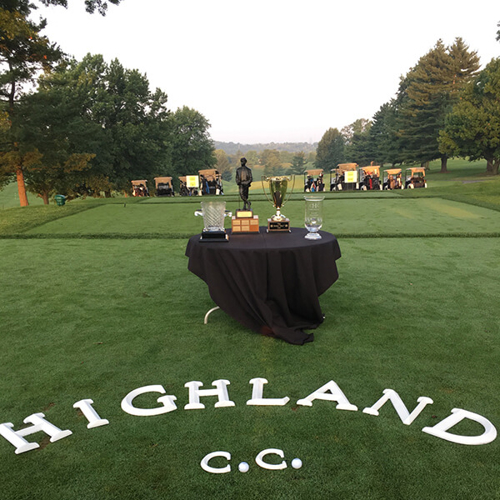 Highland C.C. word on the grass with black table and trophies