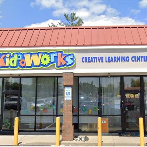 Colorful kidworks signage on the building with red roof