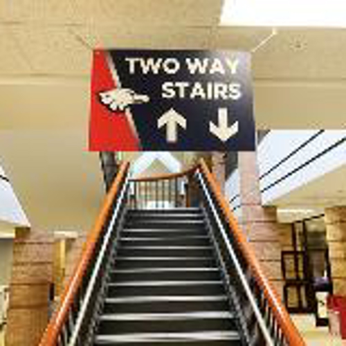 Two way stairs hanging sign above the stairs