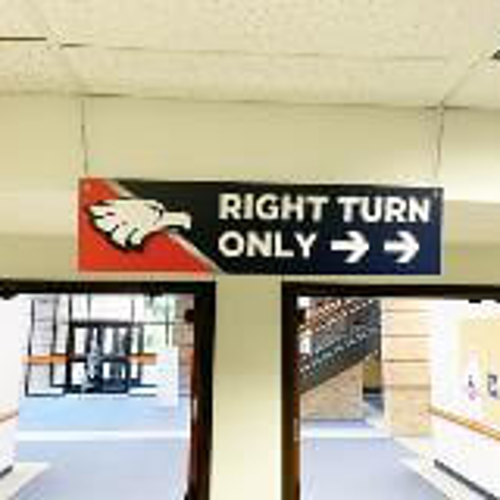 Right turn only hanging sign on the school hallway