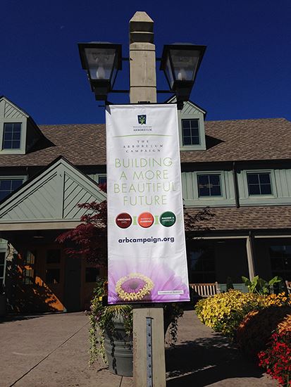 A banner hangs from a streetlight