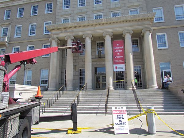 A banner hangs from outside of a college