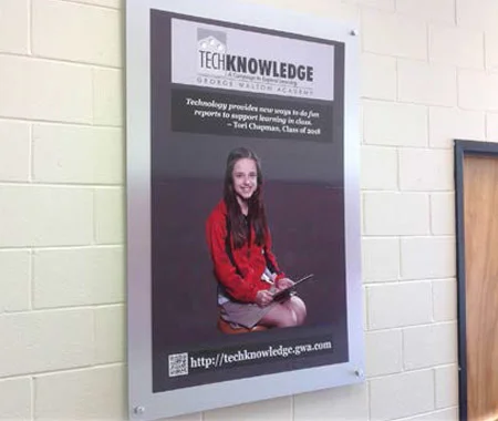 A framed wall display shows a girl with a tablet.