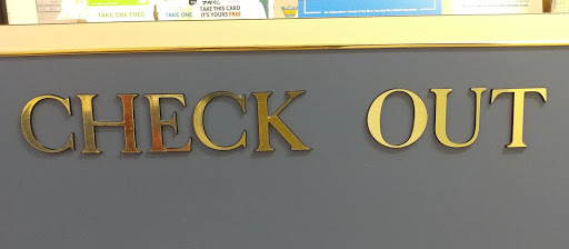 custom routed sign that reads check out