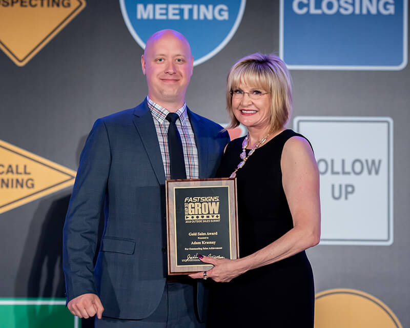 FASTSIGNS® of Toronto’s Adam Krasnay (left) receiving a Gold Sales Award at the 2019 Outside Sales Summit