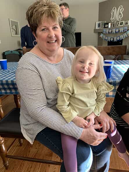 hayden in the lap of a family member