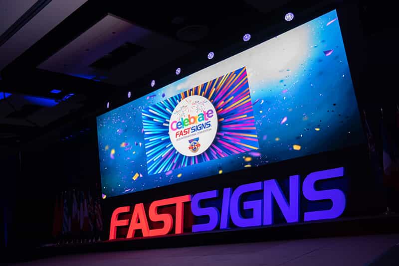 a screen celebrates FASTSIGNS