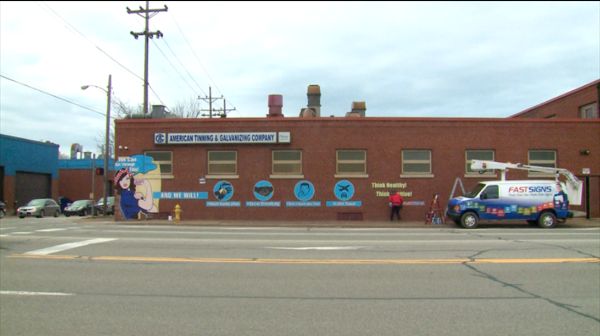 Fastsign custom graphics against COVID on a building