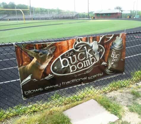 a banner is hung on a fence for the buck bomb