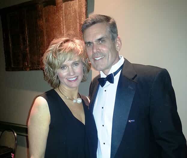 Leigh and David Rand pose together at a FASTSIGNS convention