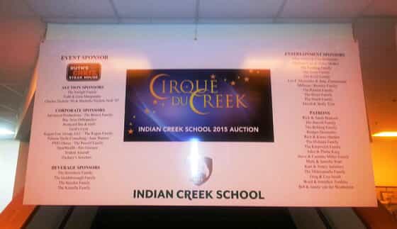 A banner shows sponsors for an auction